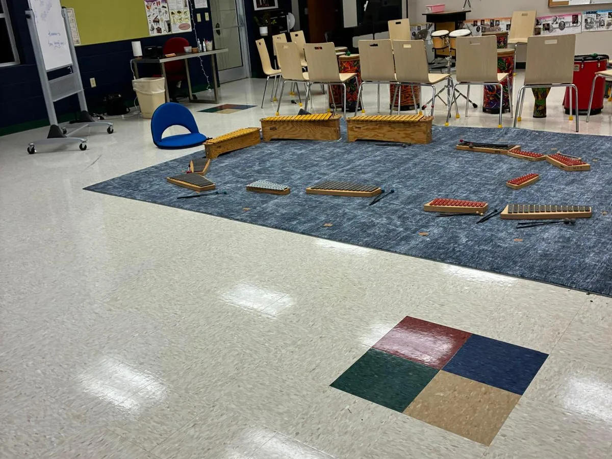Classroom with waxed tile floor and area rug after cleaning